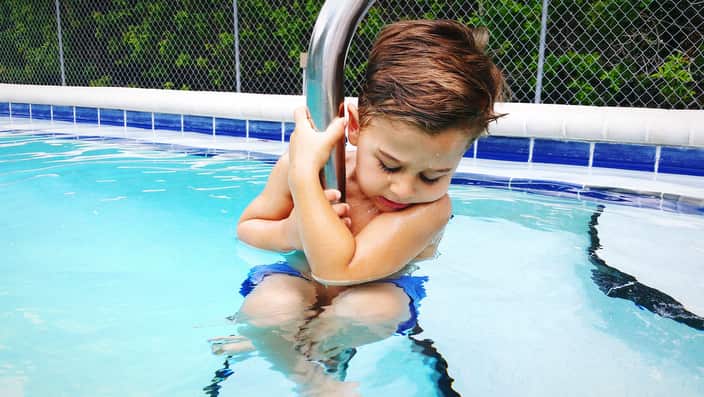 Boy Playing In Swimming Pool