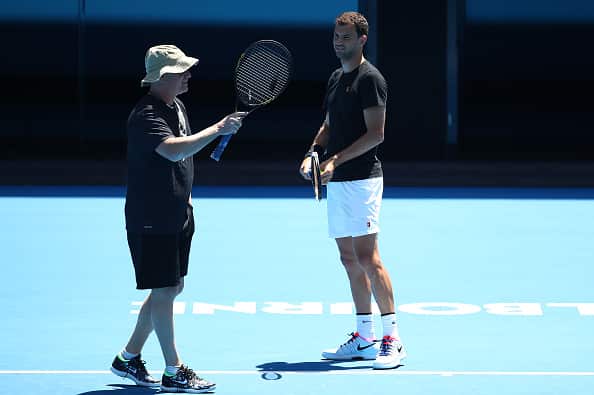 Grigor Dimitrov of Bulgaria talks with his coach Andre Agassi during a practice session ahead of the 2019 Australian Open at Melbourne Park