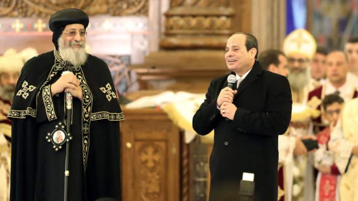 Pope Tawadros II of Alexandria (L) listens as Egyptian President Abdel Fattah al-Sisi (R)