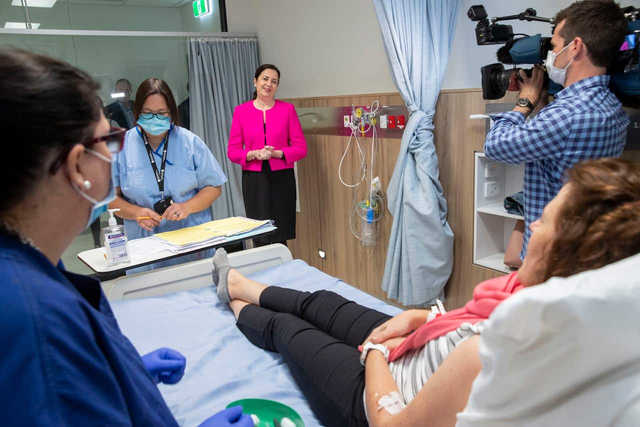 Premier Annastacia Palaszczuk speaks with the first volunteer to be given the COVID-19 vaccine.
