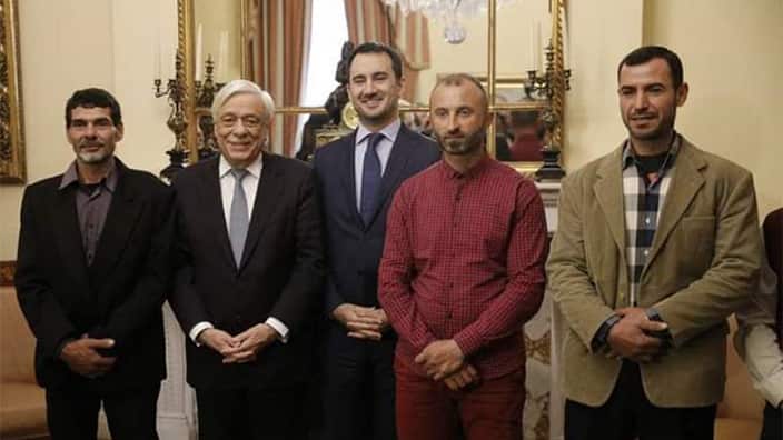 Greek President Prokopis Pavlopoulos (second left) honoring Mahmoud Moussa (far right) and the other migrants at the presidential palace