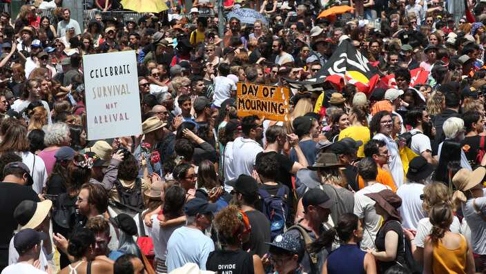 A large crowd of protesters take over the intersection in front of Flinders St Station as part of an 'Invasion Day' rally, Melbourne, Friday, January 26, 2018. (AAP Image/David Crosling) NO ARCHIVING