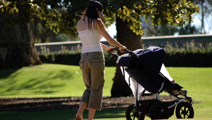 Mother pushing baby pram