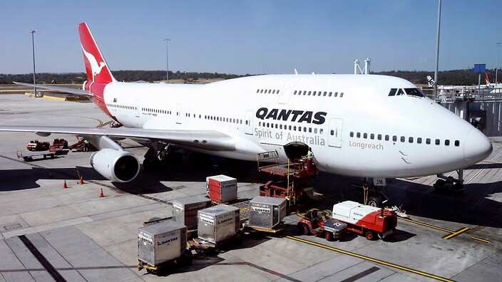 A Qantas airlines jumbo jet is loaded before departure at Tullamarine Airport in Melbourne, Australia.