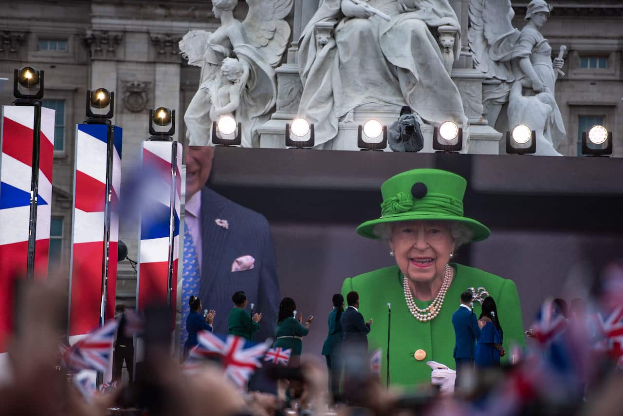 Queen Elizabeth II waves to a crowd of fans, captured onscreen, during the Queen Elizabeth II Platinum Jubilee 2022 - Platinum Pageant in London. (Photo by Loredana Sangiuliano / SOPA Images/Sipa USA)