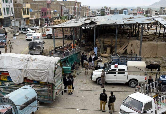 Pakistani police officials inspect the site of the attack at a fruit market in Quetta on April 12, 2019.