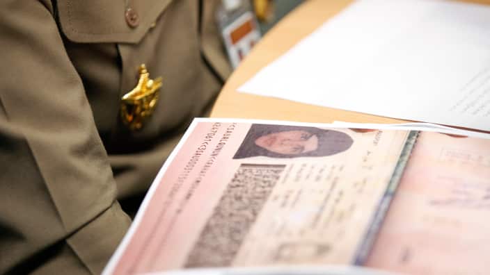 passport of Rahaf Mohammed al-Qunun is seen next to Thai Immigration Police Chief Surachet Hakparn