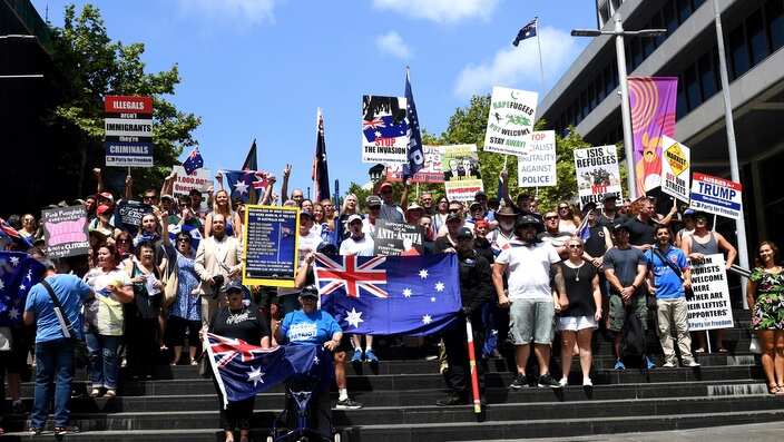 Protesters assemble for a group photograph following a Reclaim Australia rally in Sydney on Sunday, Jan. 29, 2017. (AAP Image/Paul Miller) NO ARCHIVING