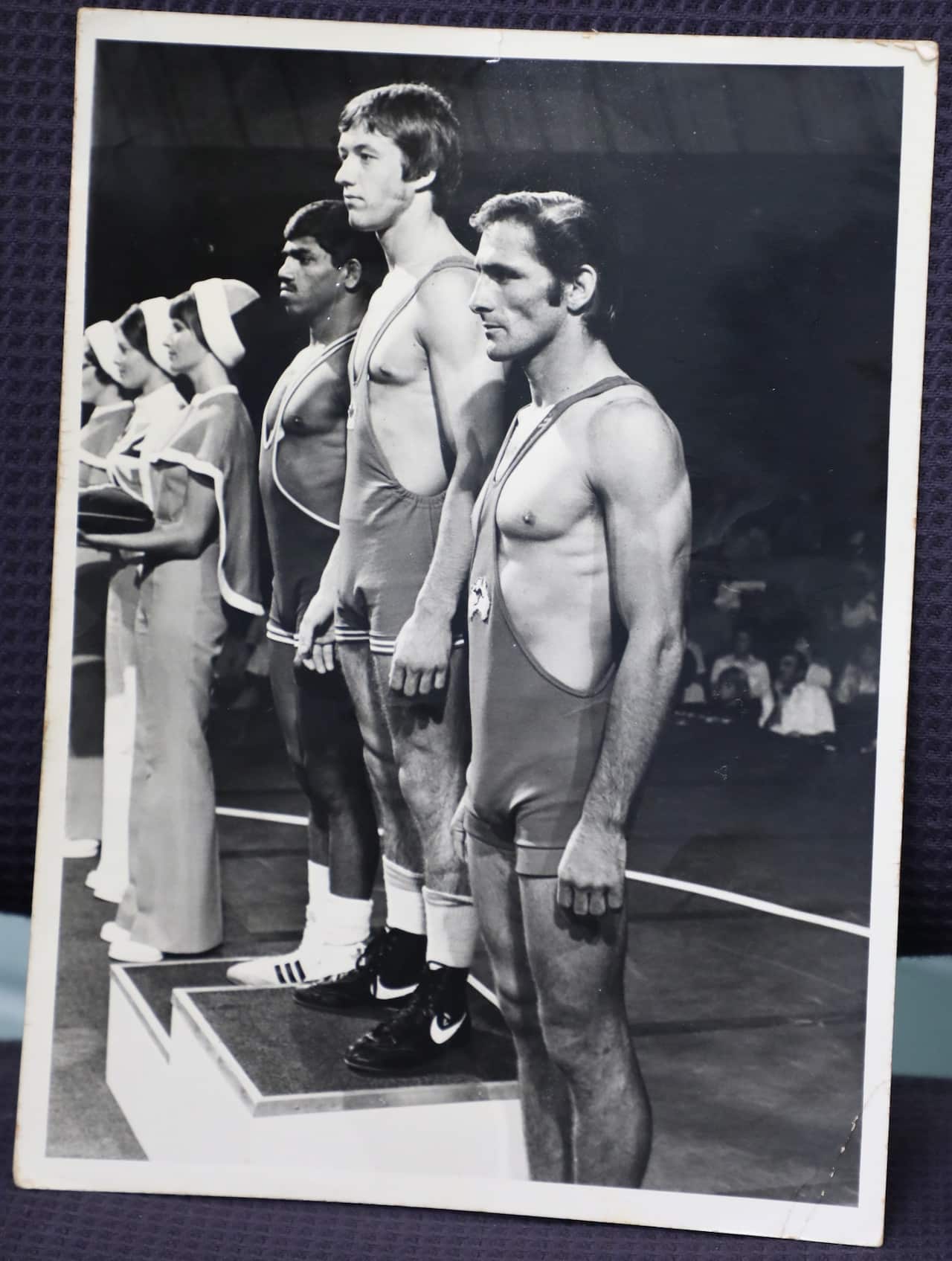 Raymond Brown (right) standing at the podium to receive bronze medal in wrestling, 1974 Commonwealth Games, Christchurch New Zealand.