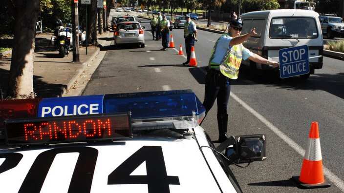 A officer has had his leg partially amputated after he and colleague were hit by a car while setting up a random breath test station in Sydney