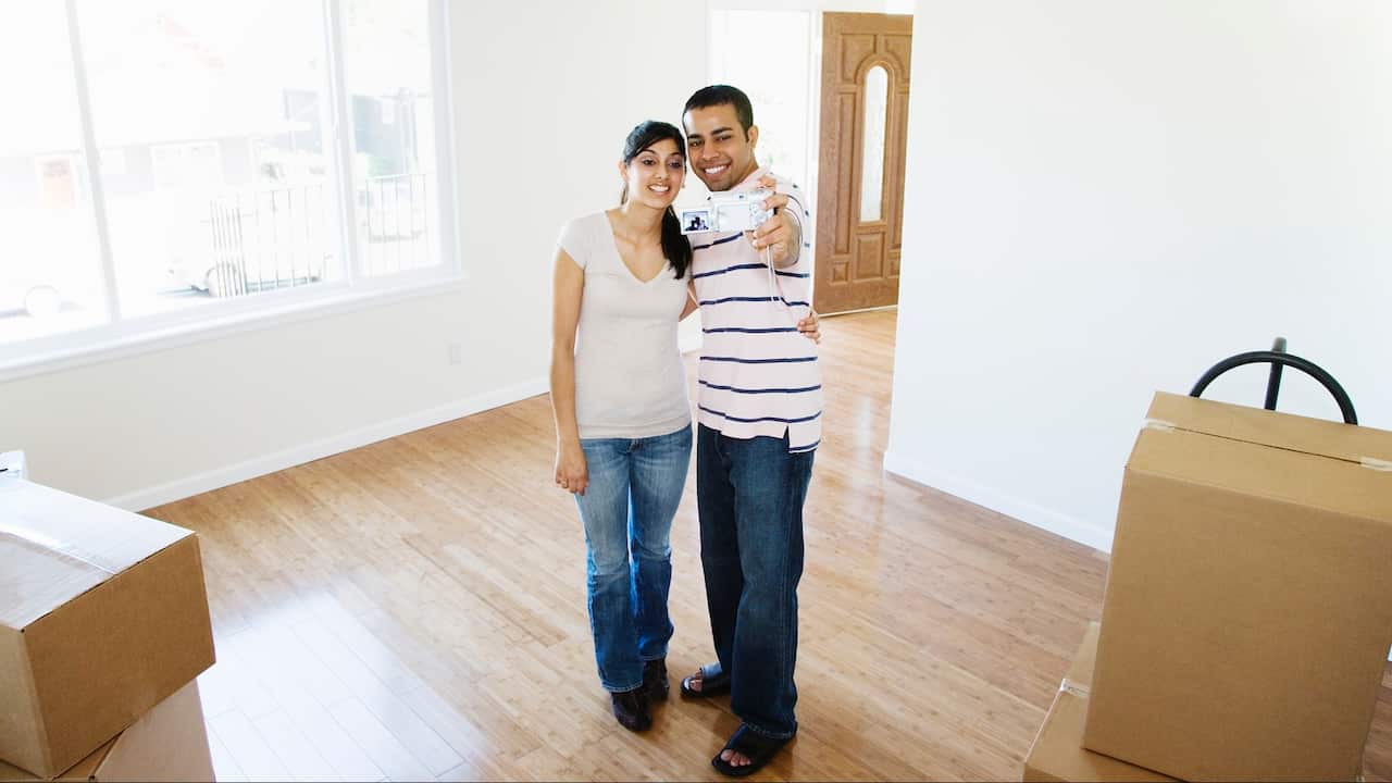Young Indian couple moving into new house