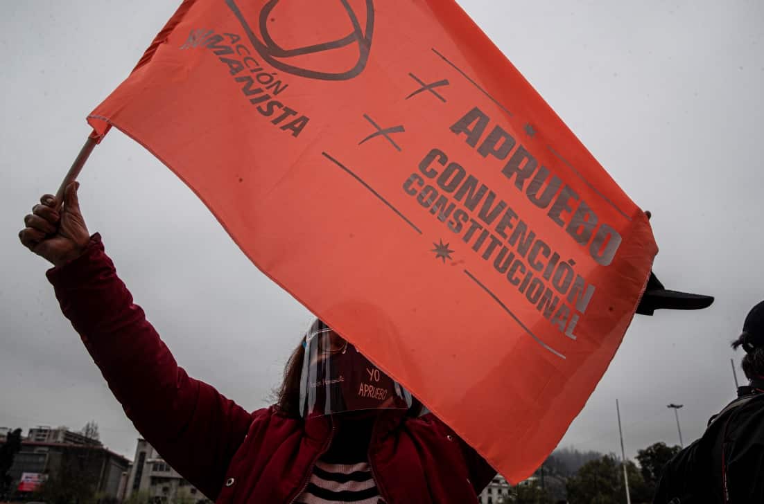 A woman holds a banner wave in favor of rewriting the Chilean Constitution ahead of a referendum on the matter.