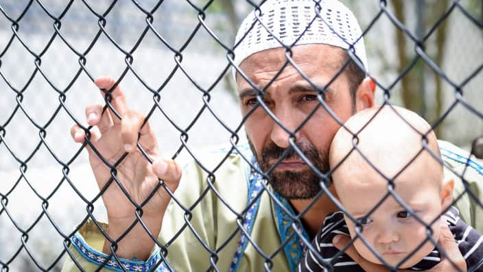 Muslim refugee holding his baby