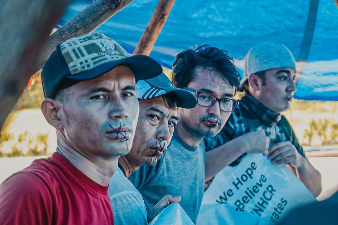 Boman Ali (3rd from the left) was among several Hazara refugees who sewed their lips.