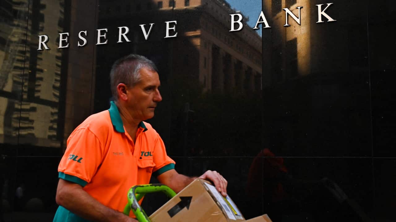 People walk past the Reserve Bank of Australia in Sydney, Tuesday, April 5, 2022.