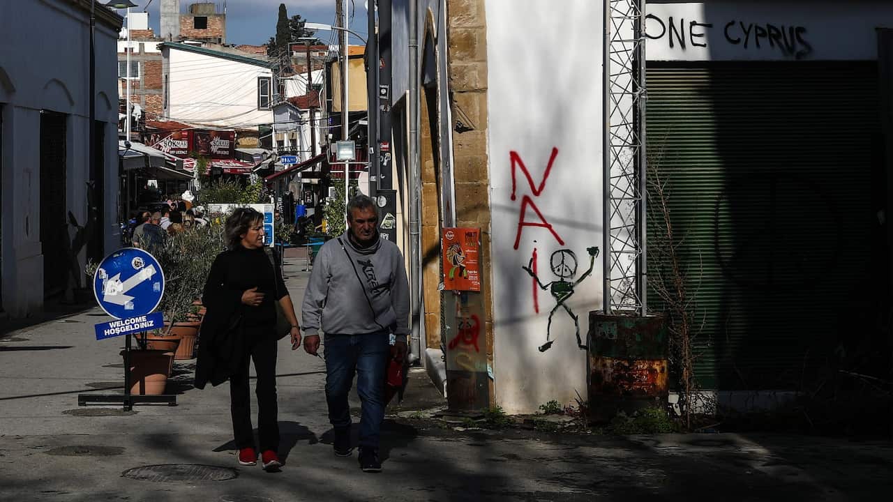 people walking in a border crossing on the Green Line cutting through central Nicosia