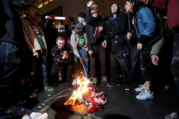 Protesters burn a flag outside Trump Tower in New York