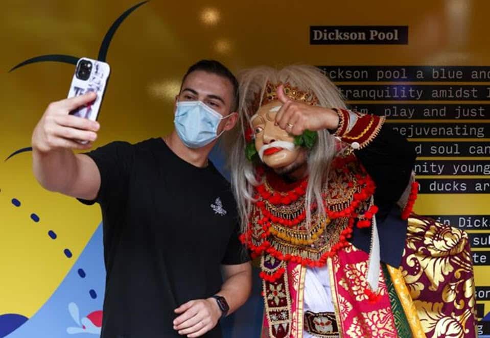 A young man takes a selfie with Eka Gede Riadi in Dixon.