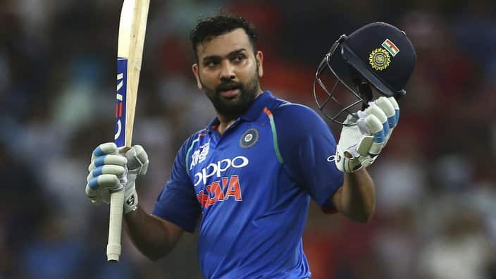India's captain Rohit Sharma raises his bat and helmet to celebrate scoring a century during the one day international cricket match of Asia Cup between India and Pakistan in Dubai, United Arab Emirates, Sunday, Sept. 23, 2018. (AP Photo/Aijaz Rahi)