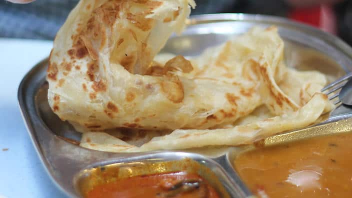 Soak up your sauce with a roti prata. Flaky, soft and crisp Indian flatbread that is cheap & cheerful.