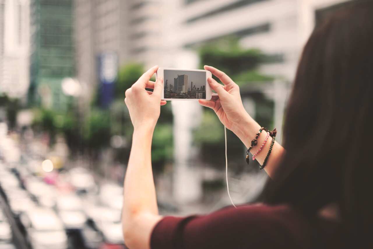Student taking picture of city