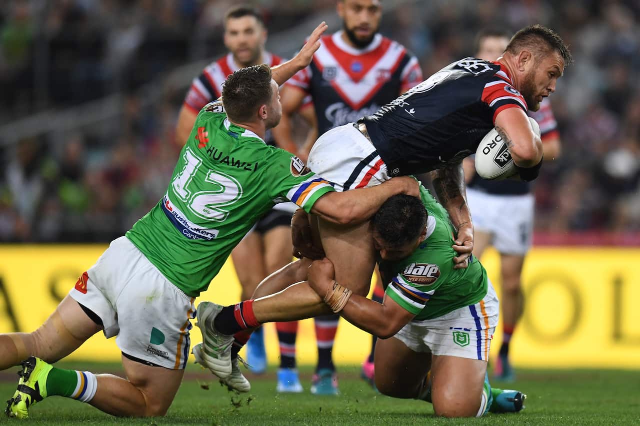 Jared Waerea-Hargreaves of the Roosters is tackled by Elliott Whitehead of the Raiders during the 2019 NRL Grand Final 