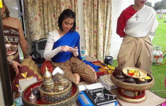 Image of Thai ladies cooking in traditional costumes from SA Thai Festival 2018