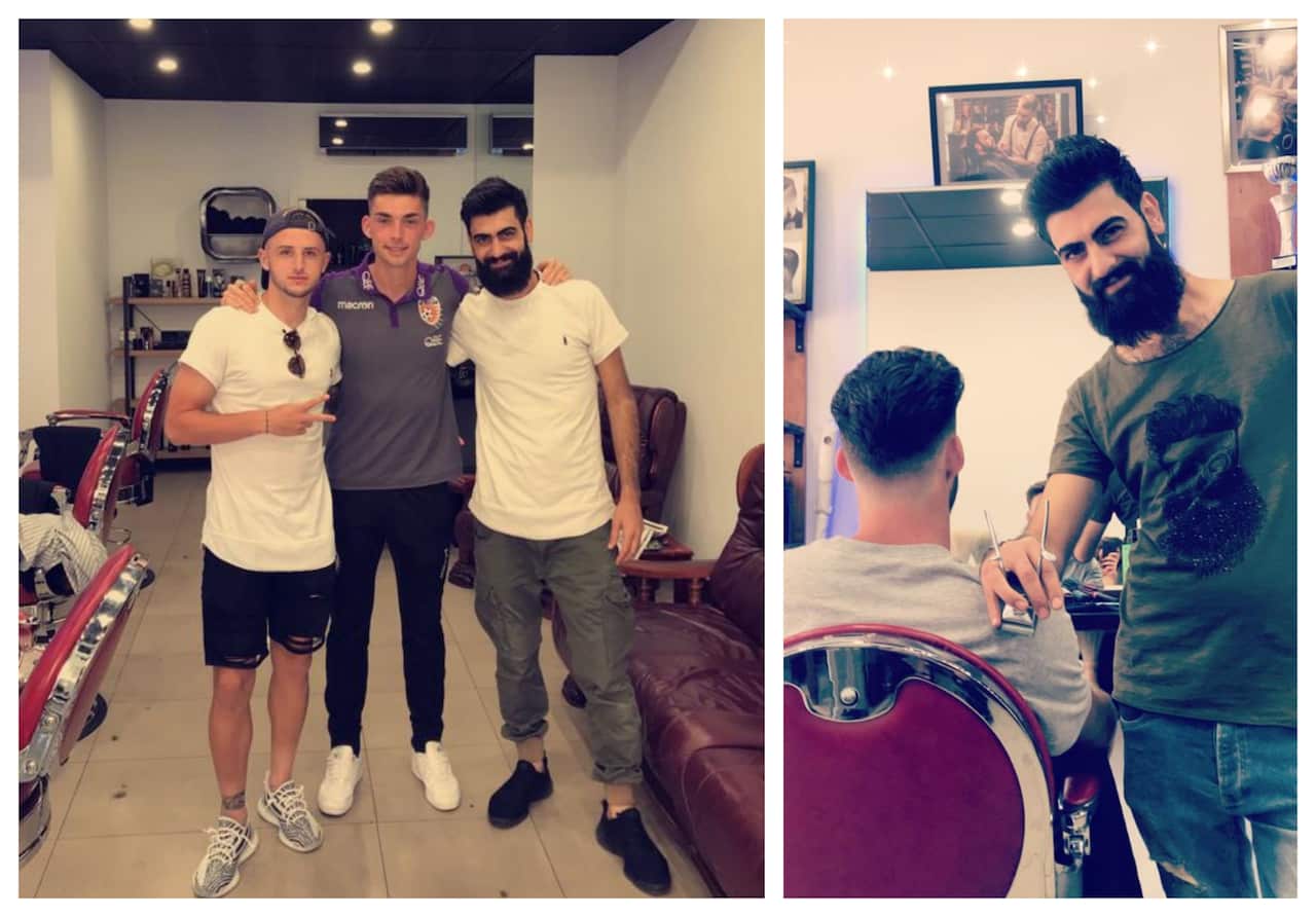 Salim Ghrli in his shop with customers 