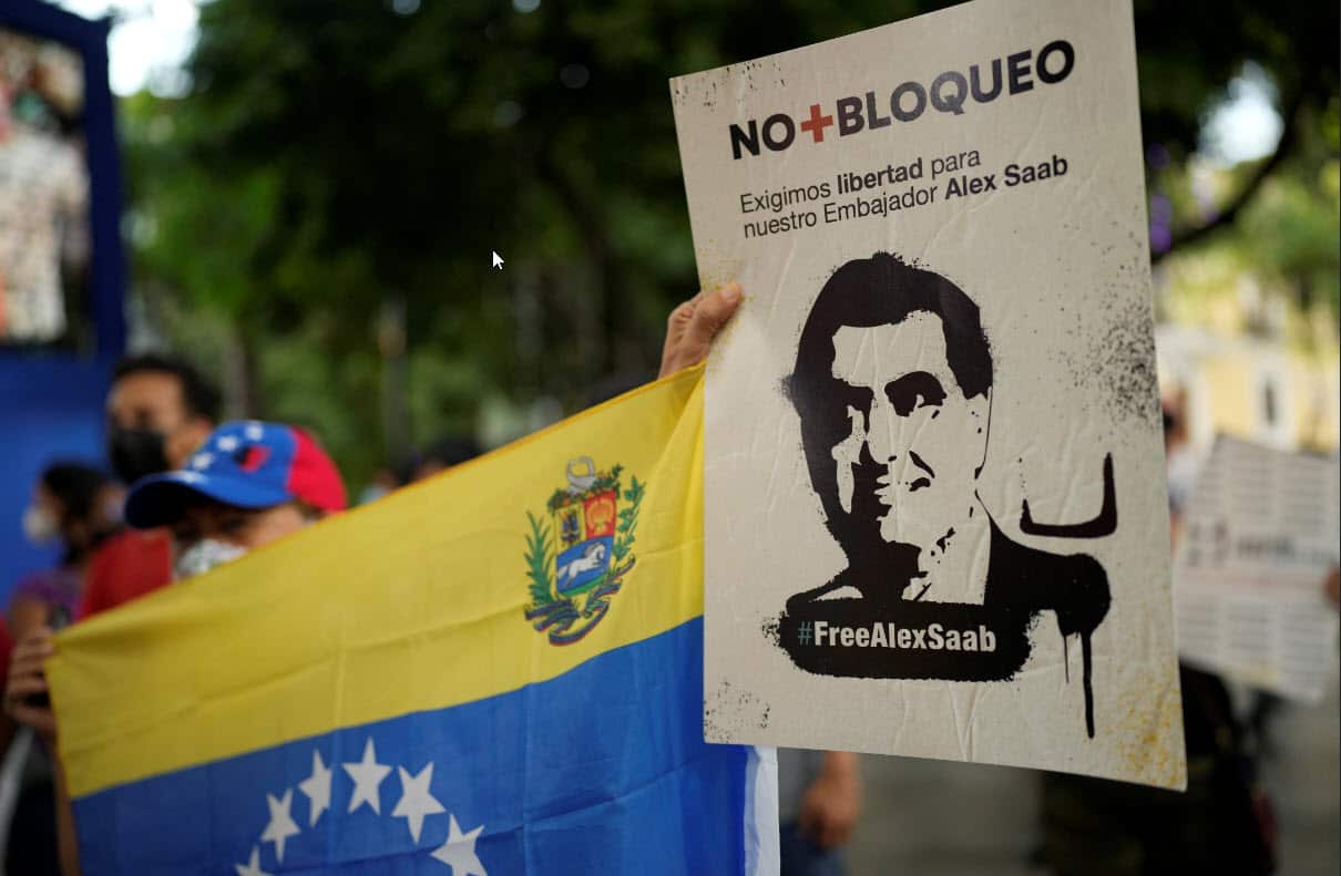 A woman holds a sign with the image of businessman Alex Saab who has been extradited to the U.S., during a demonstration demanding his release in Caracas.