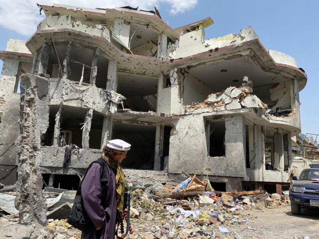 Chilean journalist, Jorge Said, walking amongst the rubble in Afghanistan. 