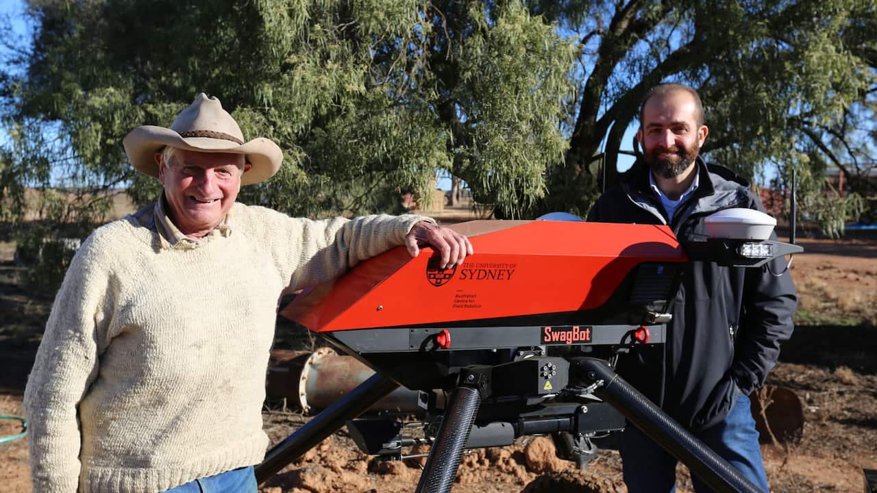 Dr Salah Sukkariah with a farmer and a bot