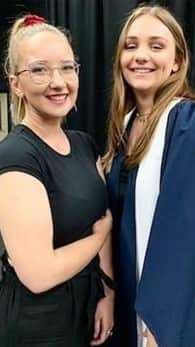 Sara Passarini (right) with a friend during her graduation ceremony