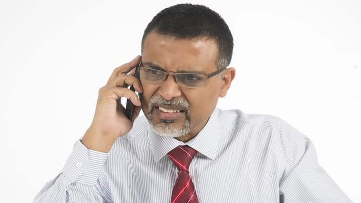Annoyed and angry businessman on phone