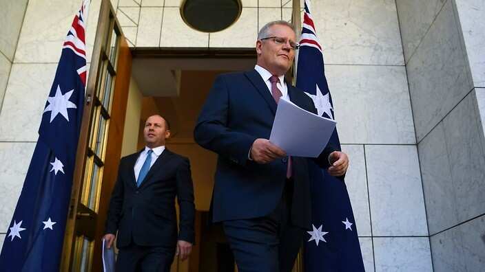 Australian Prime Minister Scott Morrison and Australian Treasurer Josh Frydenberg arrive to speak to the media during a press conference at Parliament House.