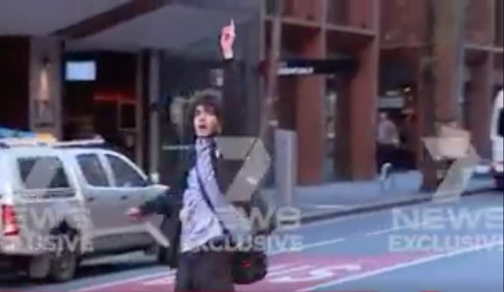 Sydney Attacker raising his finger up in the air as he shouts "Allahu Akbar"