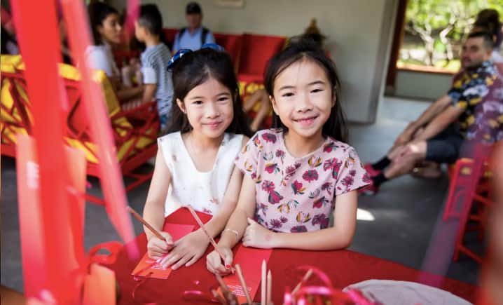 Little girls practice Chinese Calligraphy