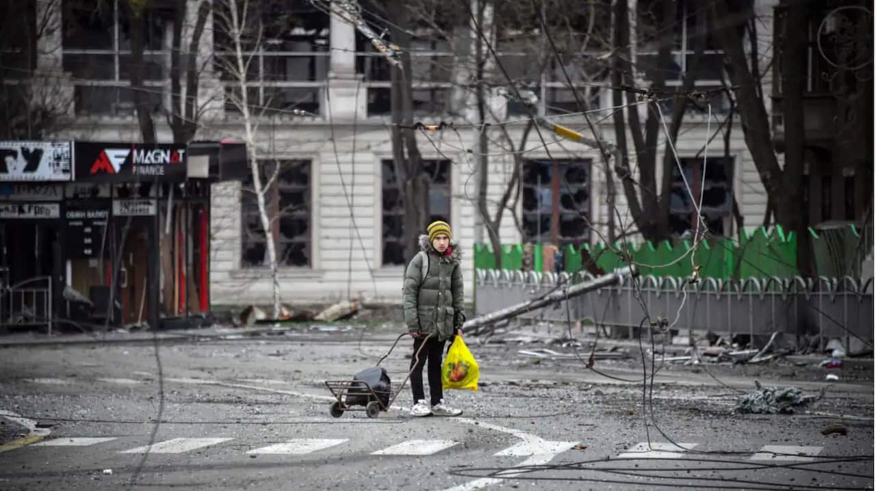 A child walks in a street of Mariupol as Russian troops intensify a campaign to take the strategic port city.