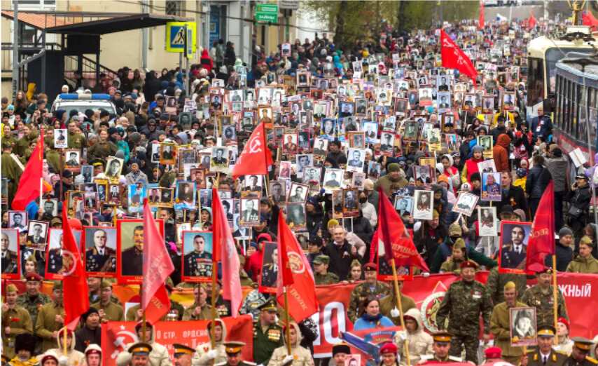 People carry a portrait of former Soviet leader Josef Stalin and portraits of Soviet leaders and relatives who fought in World War II, Russian and Soviet flags, during the Immortal Regiment march in Ulan-Ude, the regional capital of Buryatia, a region nea