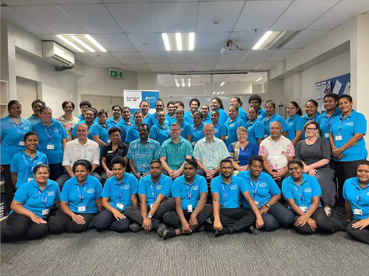 Prime Minister Anthony Albanese and Minister for the Pacific, Pat Conroy, with students and staff of the APTC in Fiji.