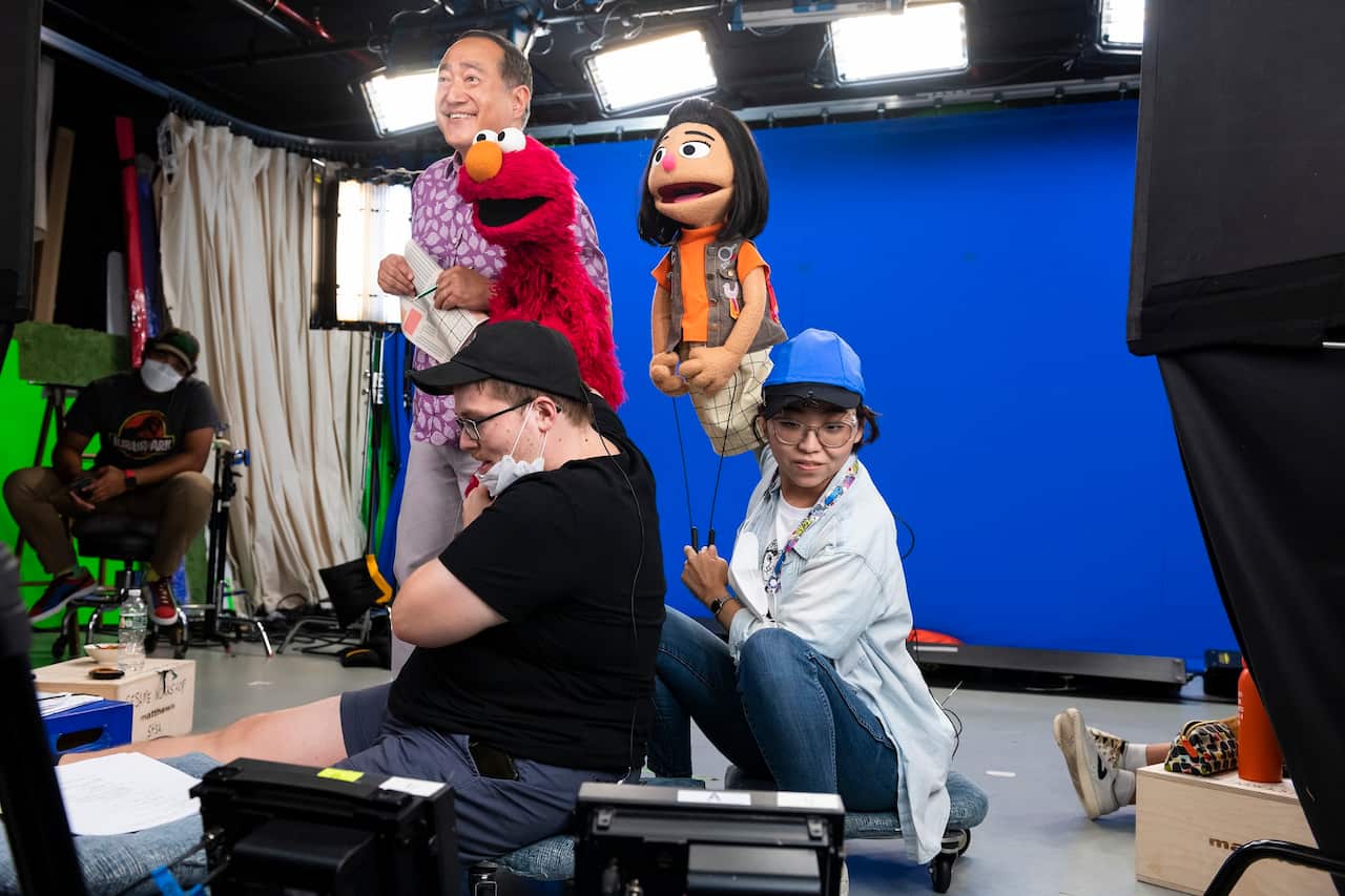 Kathleen Kim performing Ji-Young - with Alan Muraoka, puppeteer Ryan Dillon, and Elmo