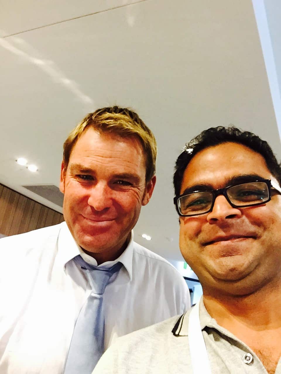 SBS journalist Sameer Ghimire (R) and Shane Warne.