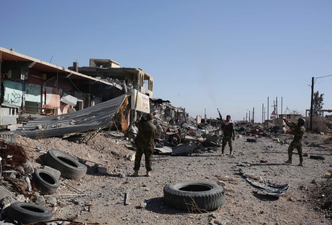In this Friday, Nov. 12, 2015, file photo, Kurdish peshmerga fighters fire into the the air while celebrating the retaking of of Sinjar, northern Iraq.