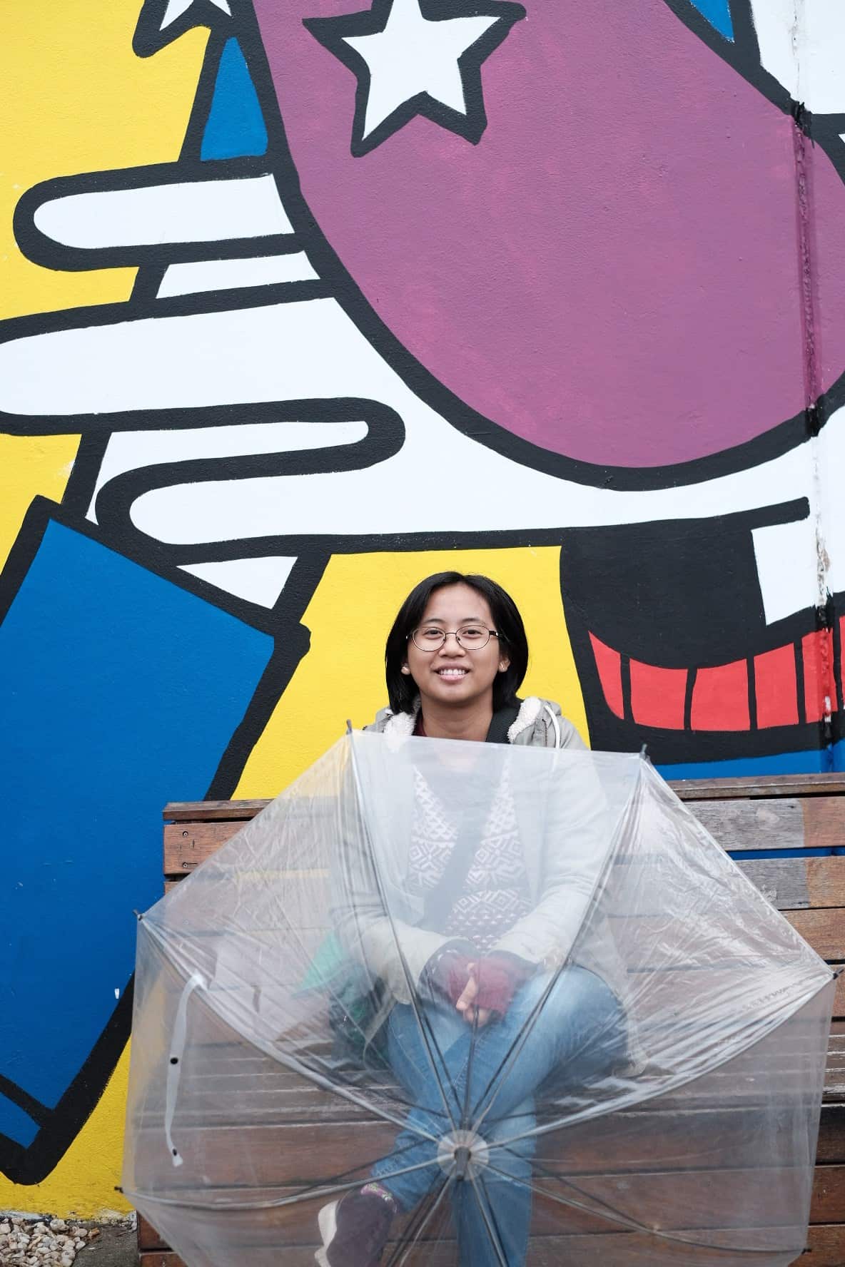 Fransiska Wuri Nugahani (Siska) taking shelter from the rain at Preston Market in Melbourne.