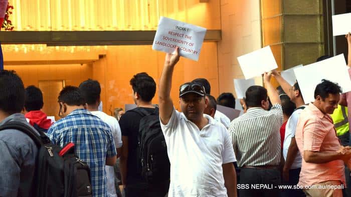A Nepali protester in Sydney's Martin place with a placard against the border blockade in Nepal on November 2015. (SBS Nepali)