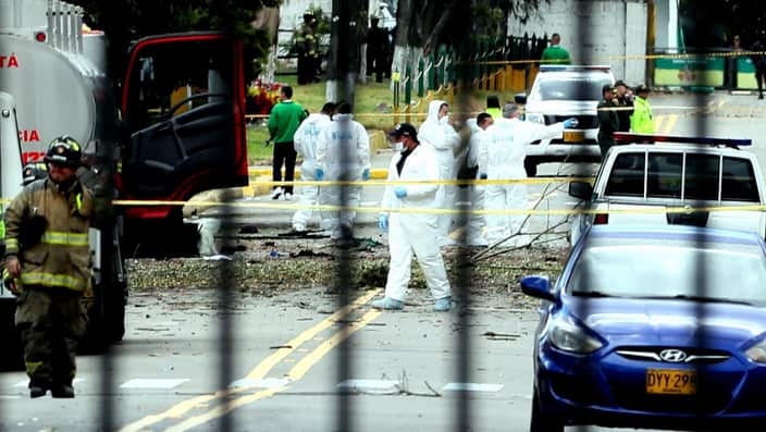  Members of the Colombian Technical Investigation Team (CTI) work at the place where a bomb car caused an explosion.
