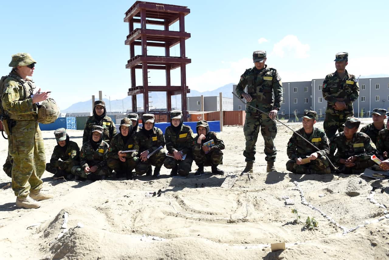 Australian Defence Force Captain Angelina Durant (left) mentors the officer cadet trainers at the Afghan National Army Officer Academy in Kabul