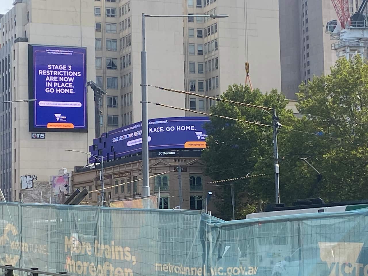 Victorian government ads on stage 3 coronavirus-related restrictions as seen in Melbourne's CBD