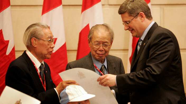 22/06/06-REDRESS EXPRESS-Prime Minister Stephen Harper, right, presented each of the surviving head