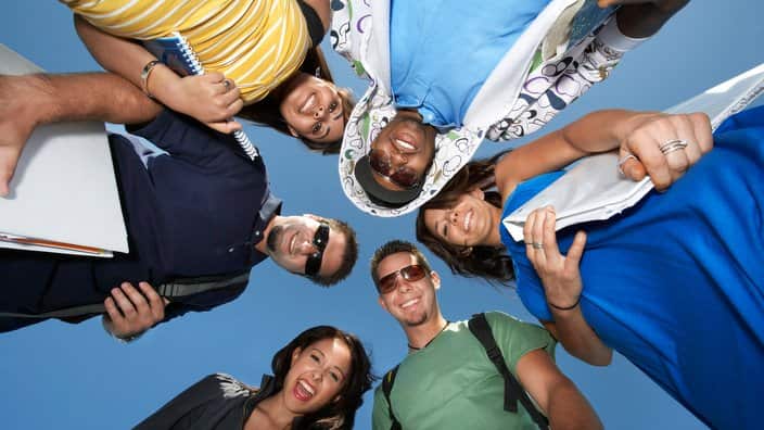 Group of college students in circle view from below