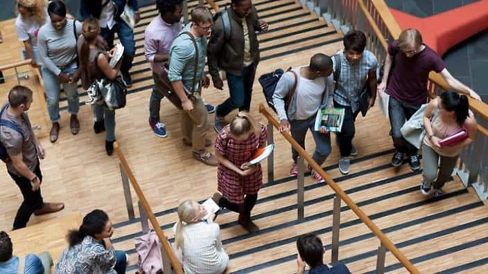 Elevated view of university students walking up and down stairs